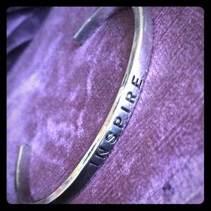 Silver tone "INSPIRE" bangle bracelet